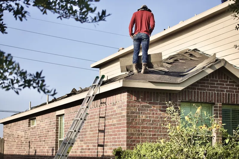 Professional roofer working on a residential roof in Martinsburg Junction